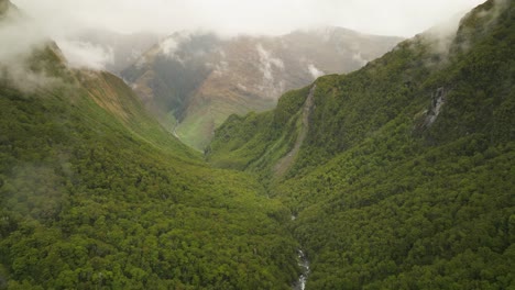 Rob-Roy-Glacier-valley-with-lush-green-forest-landscape-in-New-Zealand,-aerial