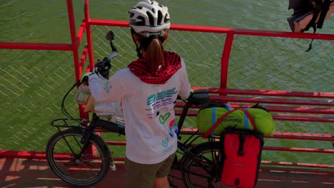 Top-shot-of-women-walking-With-cycle-in-the-boat