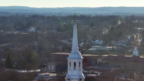 Long-aerial-zoom-of-church-steeple-during-winter-in-America