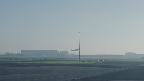 Slowmotion-tracking-shot-of-an-aeroplane-taking-off-from-the-runway-at-Rotterdam