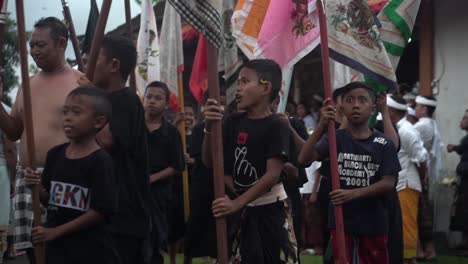 young-school-Boys-walking-in-a-line-holding-flags