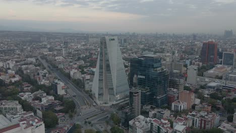 Aerial-top-down-view-of-huge-buildings-on-cloudy-day-in-Mexico-City---cinematic-footage