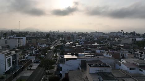 Drone-Flying-Down-Between-Buildings-In-Lima-Residential-Area,-Peru