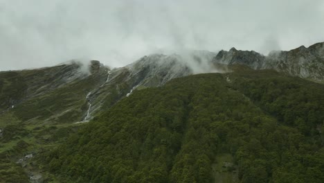 Rob-Roy-glacier-valley-on-rainy-day-with-lush-vegetation-on-mountain-slope,-aerial