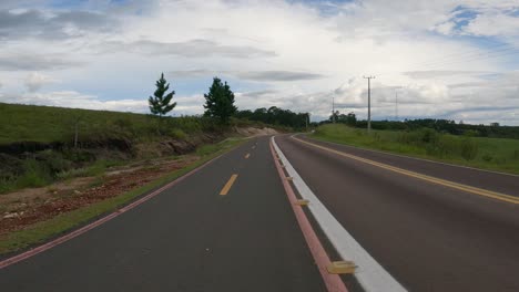 Car-traffic-on-a-road-shared-with-a-bicycle-lane,-POV-shot