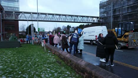 NHS-nurses-strike,-waving-banners-and-flags-demanding-fair-pay-and-better-patient-care