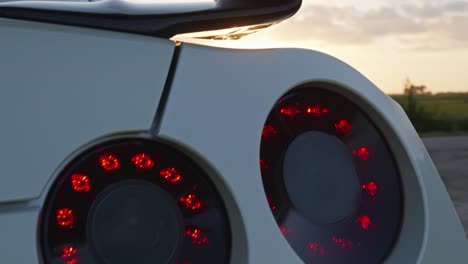 Close-up-on-rear-lamps-and-logo-of-Nissan-GRT-sport-car