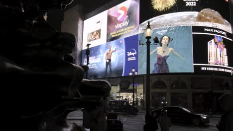 Camera-turn-from-The-Eros-statue-to-screen-lights-at-Piccadilly-Circus-at-night