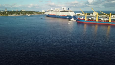 Huge-cruise-ship-leaving-the-pier-and-turning-to-head-out-of-the-port-toward-open-ocean-loaded-with-passengers-for-a-Caribbean-vacation