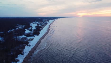 Calm-waves-on-the-shore-of-the-Baltic-sea,-aerial-view-on-blue-hour