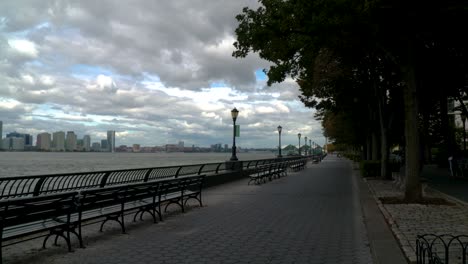 Gorgeous-NYC-sky-over-the-Hudson-River-bike-path-as-a-jogger-runs-into-and-through-the-shot