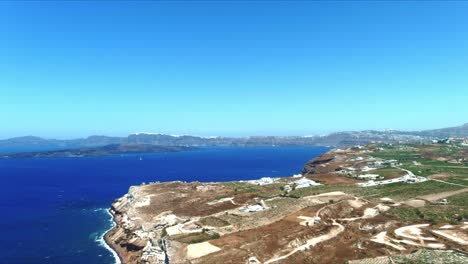 Aerial-4K-Blue-Sea-and-Sky-Top-View-Over-Akra-Mavro-Vouno-in-Santorini-Greece