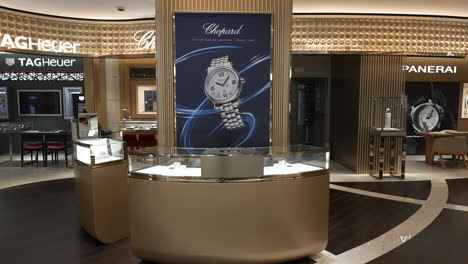 Chopard-brand-advertisement-inside-luxurious-golden-Barcelona-jewellery-store-slow-push-in-shot