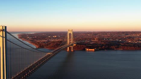 Aerial-view-overlooking-the-Verrazzano-Narrows-Bridge,-winter-sunset-in-NY,-USA
