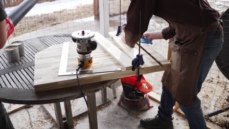 Woodworkers-using-a-leaf-blower-to-clear-Sawdust-from-their-workstation