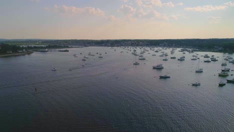 Massachusetts-harbor-with-boats-and-sailboats,-sunny,---Drone-video