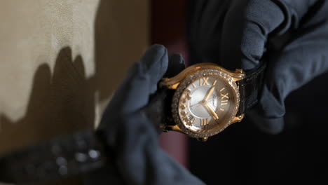 VERTICAL-Horologist-picking-up-luxury-gold-with-floating-sparkling-diamonds-Chopard-brand-watch