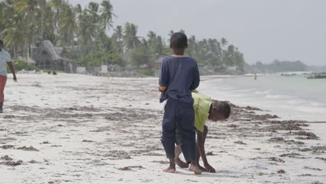 Two-young-black-African-boys-playing-and-having-fun-on-Tanzania-beach