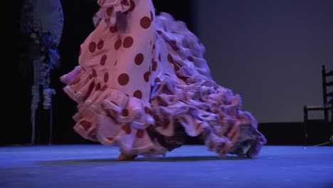 Flamenco-Tänzerin-Tritt-Hart-Auf-Und-Bewegt-Den-Schwanz-Des-Rosafarbenen-Kleides-Mit-Roten-Tupfen-Auf-Der-Bühne