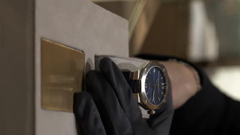 VERTICAL-Close-up-hands-showing-luxury-Baume-Mercier-watch-in-presentation-display