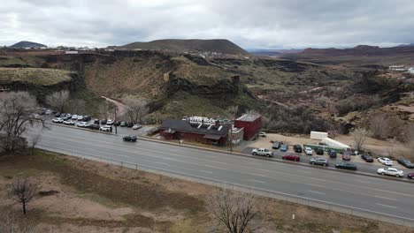 Orbiting-aerial-hyper-lapse-of-the-River-Rock-Roasting-Company-in-La-Verkin,-Utah