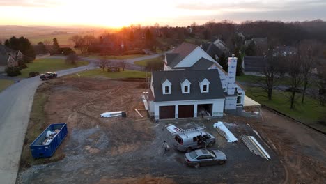 Aerial-orbit-of-construction-workers-on-site-at-new-home