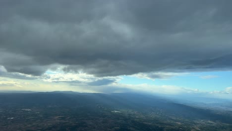 Aerial-view-from-a-jet-cockpit,-pilot-point-of-view,-while-flying-bellow-a-grey-stratus-layer-SE-Spain,-at-6000m-high