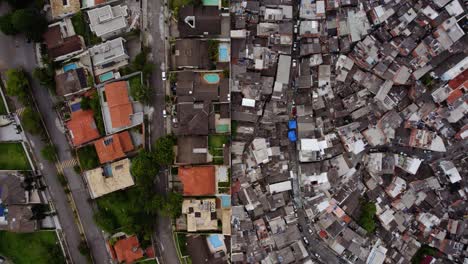 Aerial-view-above-a-wall-splitting-the-poor-from-the-rich-in-a-South-American-metropolitan-city---overhead,-drone-shot
