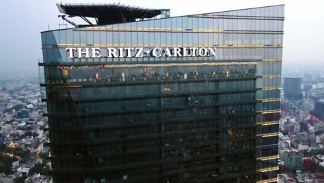 Boom-up-aerial-view-of-the-front-of-The-Ritz-Carlton-hotel-tower-on-Reforma-Avenue-in-Mexico-City,-a-new-and-vanguard-building