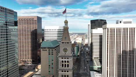 Drone-tilt-down-view-from-Daniels-and-Fisher-tower-toward-ice-rink,-Skyline-Park