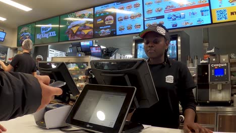 Burger-King's-employee-making-food-order-from-customer-on-touch-screen-of-computer-inside-the-restaurant---Brussels,-Belgium