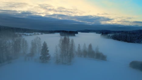 Drone-flying-through-mist-on-snowy-fields-on-a-sunny-winter-morning