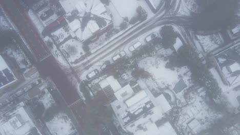 Top-down-aerial-of-beautiful-snow-covered-suburban-neighborhood