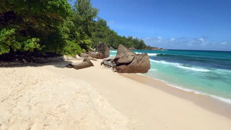 mahe-Seychelles,-Intendance-beach,-moving-towards-the-rocks