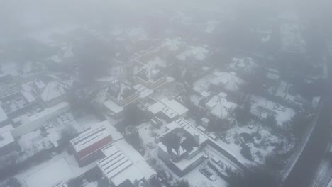 Aerial-of-beautiful-suburban-neighborhood-in-a-cold-and-foggy-winter