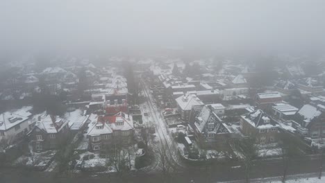 Aerial-of-beautiful-suburban-neighborhood-on-a-cold-and-misty-winter-day
