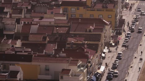 Street-full-of-people-and-houses-rooftops-of-Nazare-city-or-village-in-Portugal,-everyday-life-with-copy-space