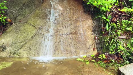 Mahe-Seychelles-small-river-formed-after-heavy-rain,-water-coming-down-from-rock