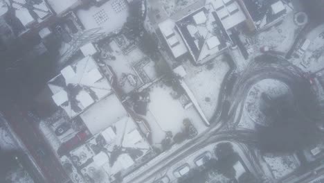 Top-down-aerial-of-snow-covered-neighborhood-in-cold-weather-conditions