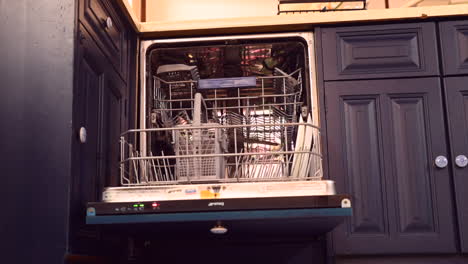 Time-lapse-of-a-man-emptying-and-filling-a-dishwasher-at-home