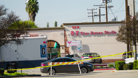 A-Wide-Shot-of-the-Star-Ballroom-Dance-Studio-Crime-Scene-behind-Caution-Tape-the-Morning-after-the-Shooting