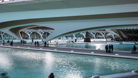 Motion-time-lapse-of-tourists-walking-under-Montolivet-Bridge,-City-of-Arts-and-Sciences,-Valencia,-Spain