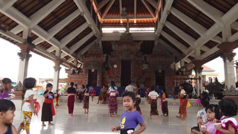 Balinese-Dance-Class-Rehearsal-For-Children,-Little-Girls-with-Traditional-Clothes-Practice-Legong-Choreography-at-the-Banjar-Building-in-Sukawati,-Bali,-Indonesia