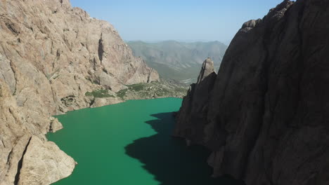 Epic-cinematic-drone-shot-inside-the-ravine-surrounding-the-Kel-Suu-lake-in-Kyrgyzstan
