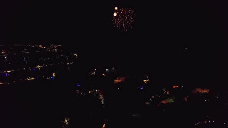 Aerial-slowly-moving-backwards-away-from-fireworks-celebration-at-night-over-Mindarie-Marina-in-Perth-Western-Australia