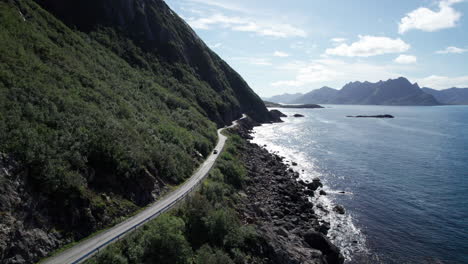 Cars-driving-on-a-famous-Norwegian-costal-road-during-summer-in-Northern-Norway,-Aerial-forwarding-shot