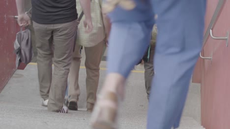 Steady-shot-of-people-walking-down-stairs-outside-on-a-summer-day-in-Stuttgart,-Germany,-in-a-documentary-style-with-everything-in-focus