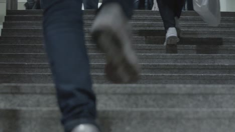 People-calmly-ascend-subway-stairs-in-Stuttgart,-Germany