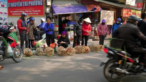 Static-shot-of-people-waiting-at-the-side-of-the-road-with-bikers-driving-past