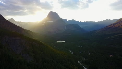 Aerial:-Sun-rises-over-green-rocky-mountain-valley-in-Banff-Nat'l-Park